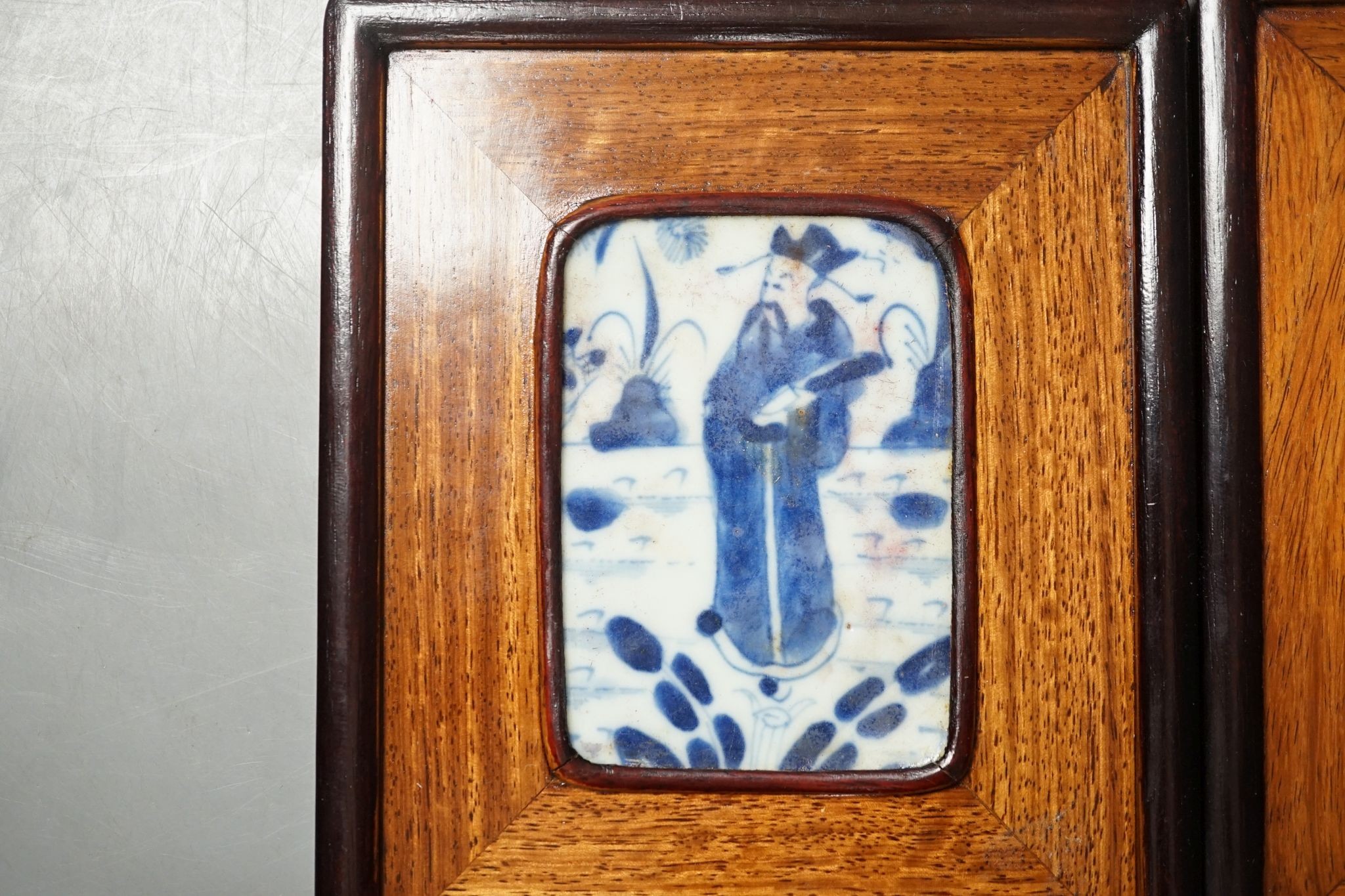 A pair of Chinese framed blue and white tiles, total size 16 cm X 13.5 cm